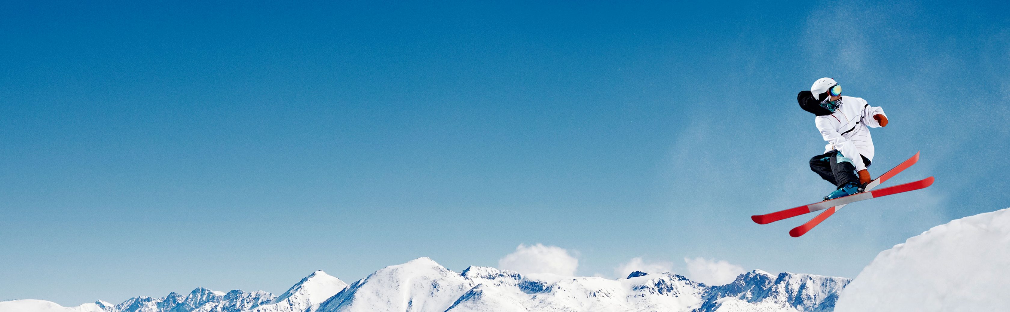 Athlete skier jumps over mountain